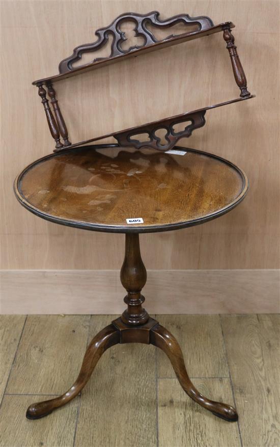 A circular tripod table with dished top and a small mahogany hanging shelf